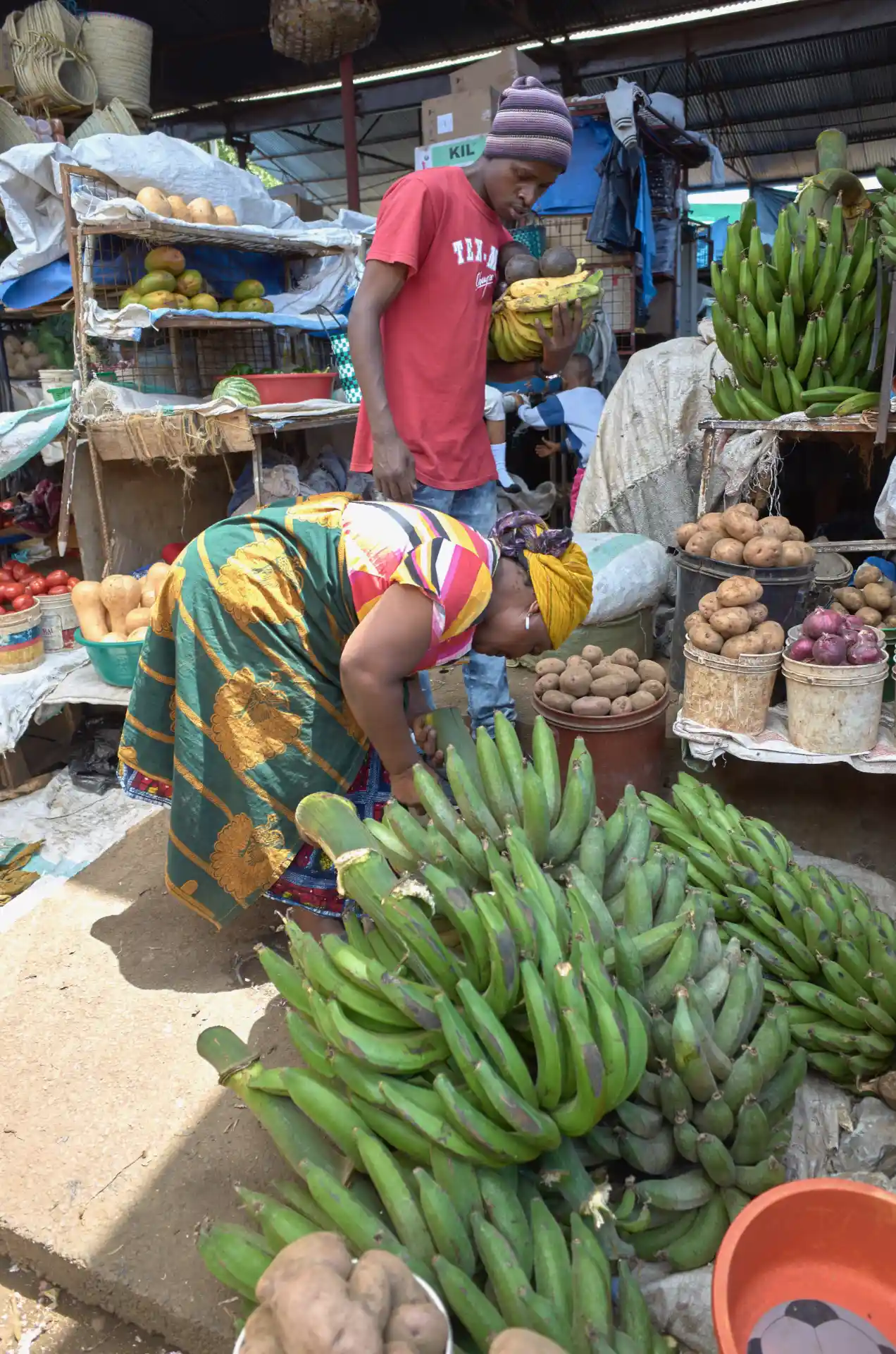 The vibrant stalls of Arusha's Central Market]
[IMAGE:arusha-market-1.webp:Local vendors at Arusha's bustling Central Market