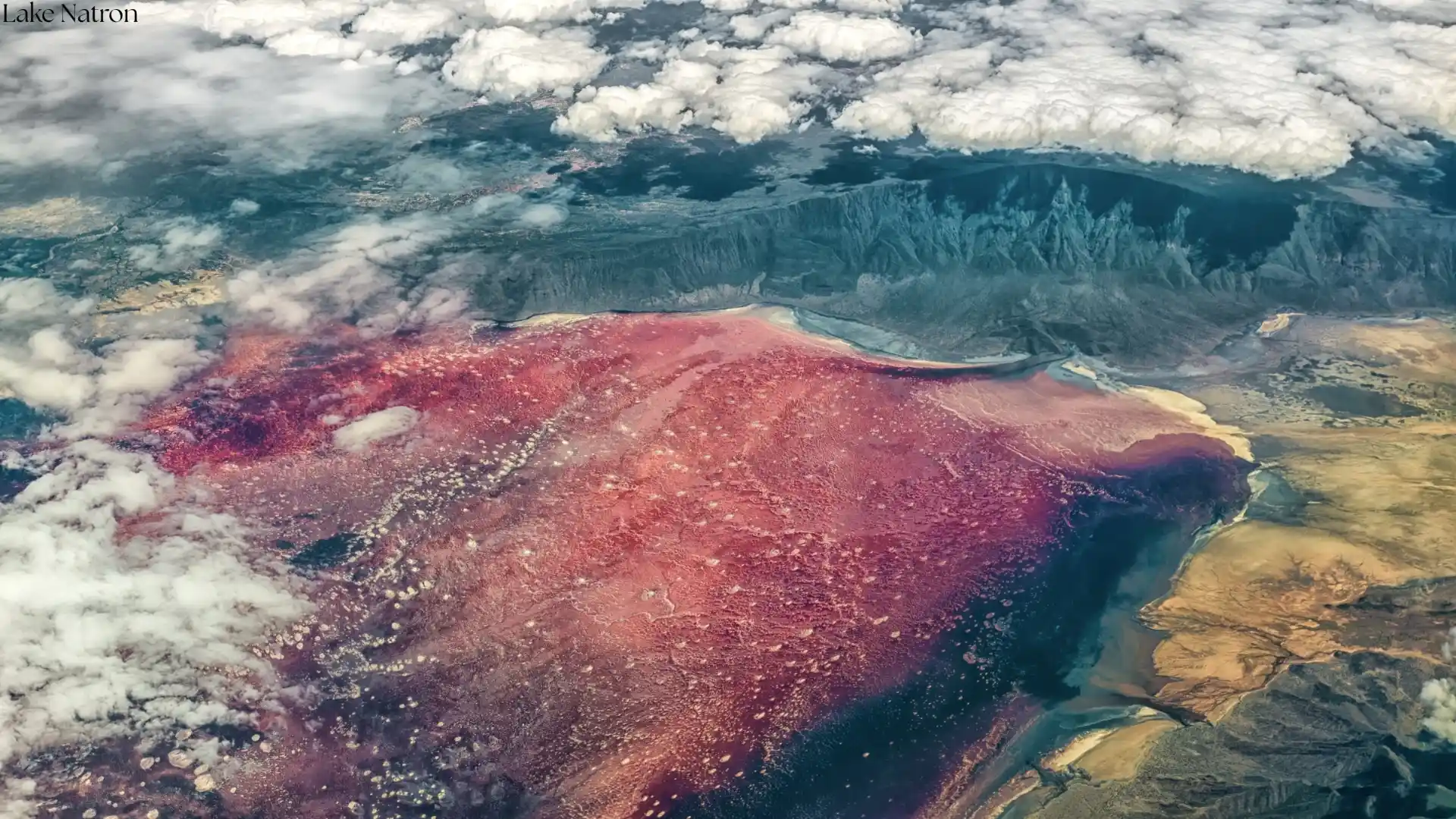 Dramatic red salt crusts at Lake Natron Tanzania - alkaline formations from aerial perspective