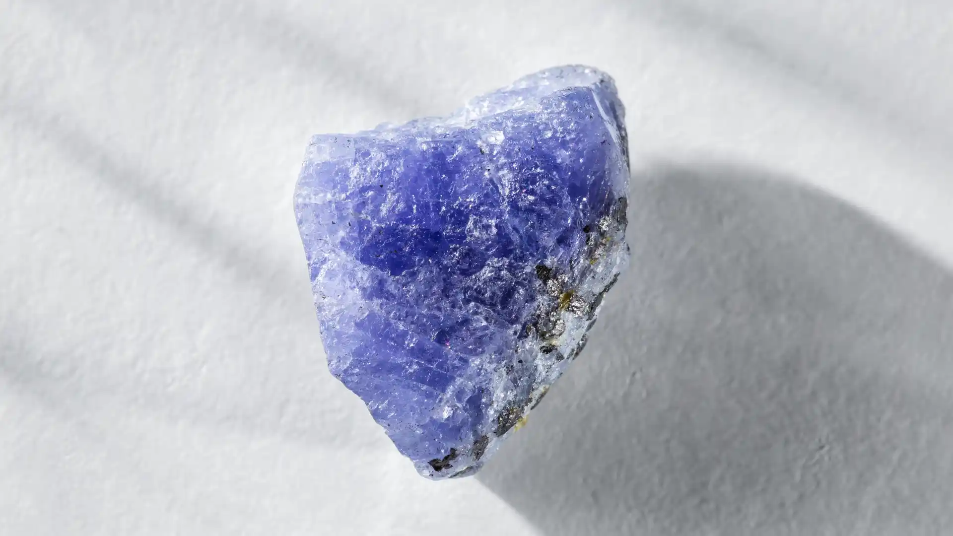 Rough uncut tanzanite crystal showing the stone before cutting and polishing at Merelani, Tanzania - Porcupine Tours
