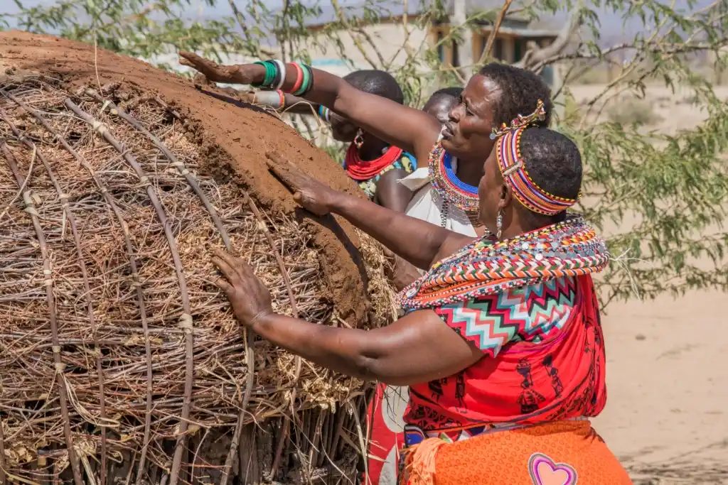 Women of Umoja constructing traditional banda accommodation for the campsite - Porcupine Tours