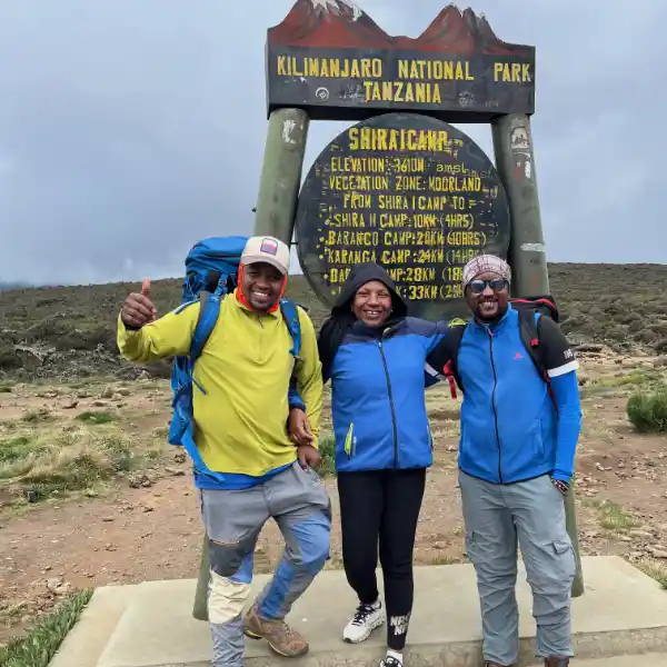 Trekker at Shira Camp with Mount Kilimanjaro's Kibo peak in background - Porcupine Tours